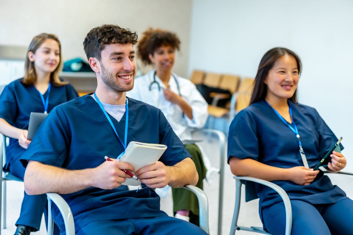 Group of medical students listening attentively to a lecture in a bright classroom